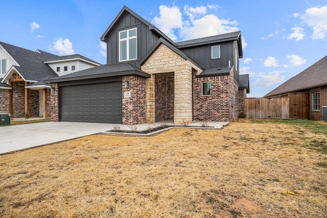 view of front facade featuring driveway, brick siding, board and batten siding, and fence