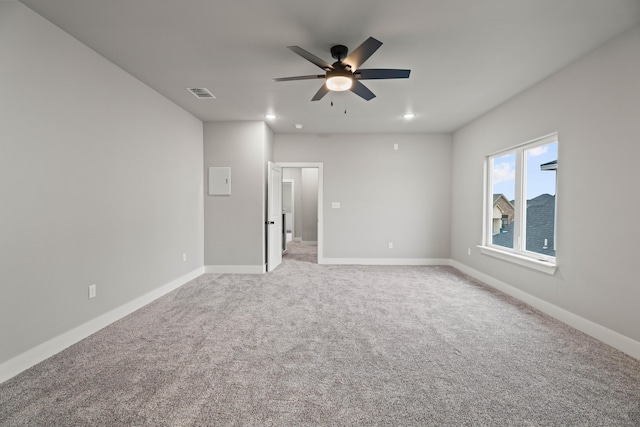 spare room featuring carpet, visible vents, baseboards, and ceiling fan