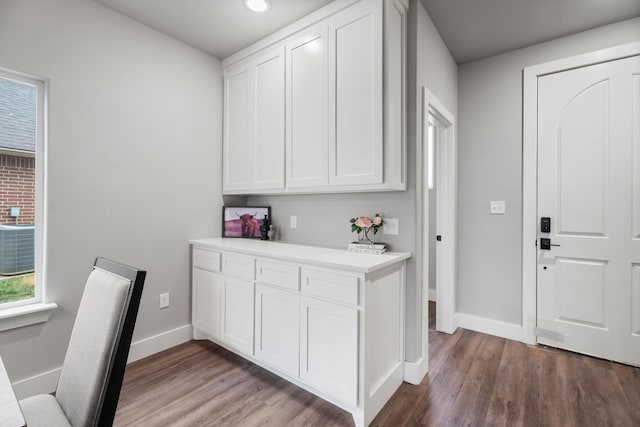 kitchen featuring light countertops, dark wood-type flooring, plenty of natural light, and white cabinetry