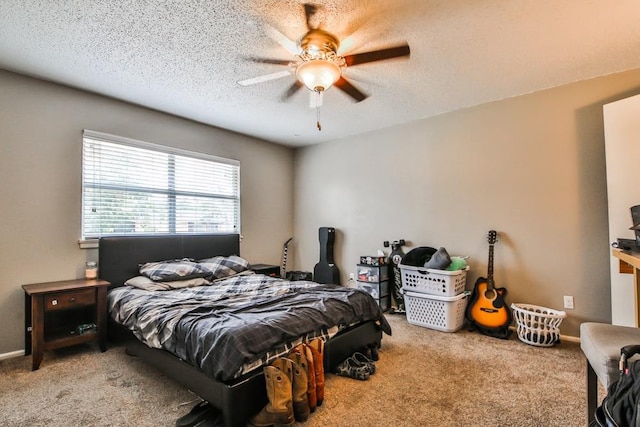 carpeted bedroom with ceiling fan and a textured ceiling