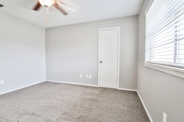 spare room featuring carpet flooring and ceiling fan