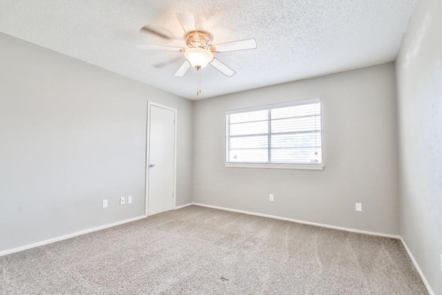 unfurnished room featuring ceiling fan, carpet floors, and a textured ceiling