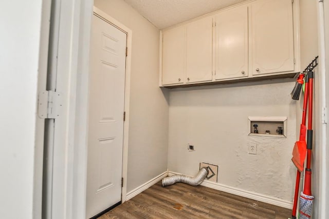 washroom featuring cabinets, a textured ceiling, dark hardwood / wood-style floors, hookup for a washing machine, and electric dryer hookup