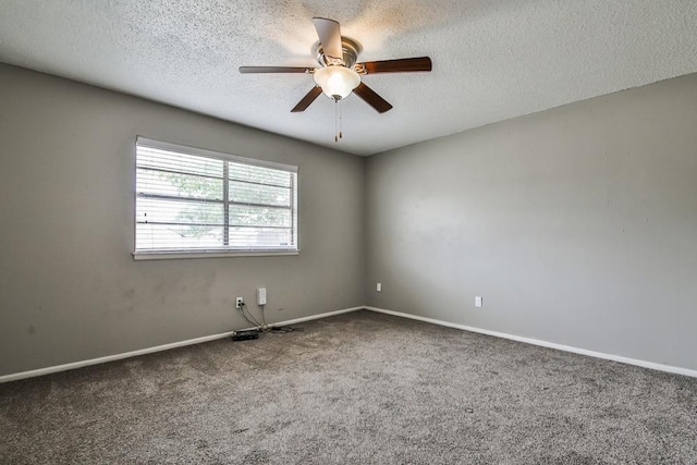 empty room featuring ceiling fan, carpet floors, and a textured ceiling