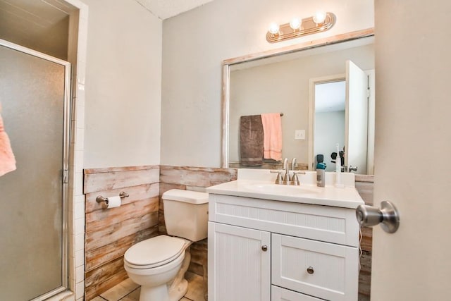 bathroom with vanity, a shower with shower door, and toilet