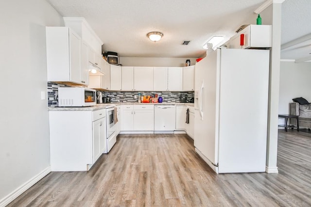 kitchen with white cabinetry, a textured ceiling, light wood-type flooring, white appliances, and backsplash