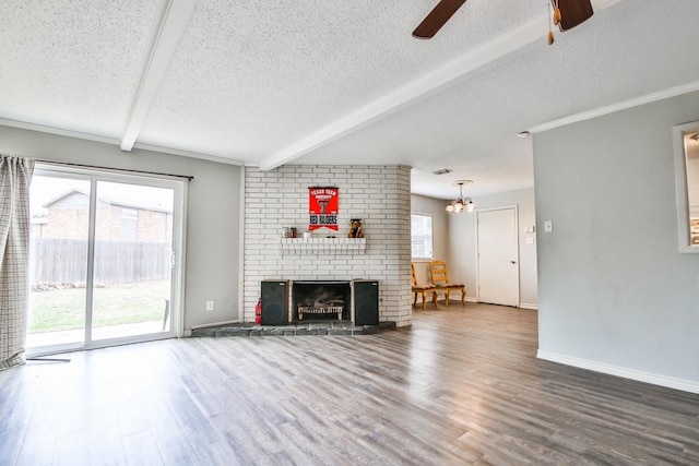 unfurnished living room with beamed ceiling, hardwood / wood-style floors, a textured ceiling, and a fireplace