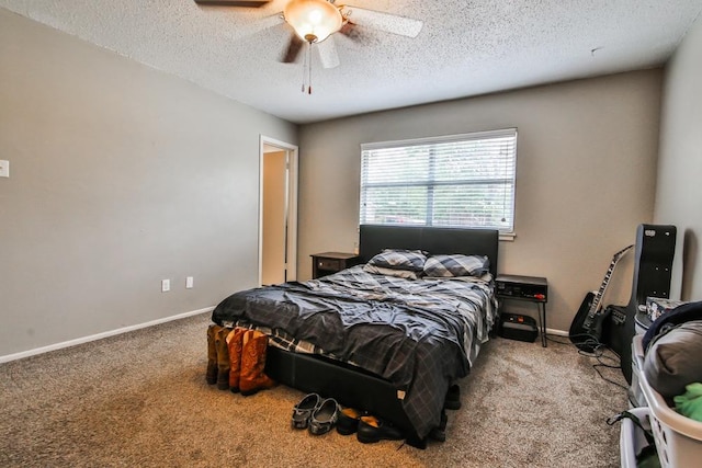 bedroom featuring ceiling fan, a textured ceiling, and carpet