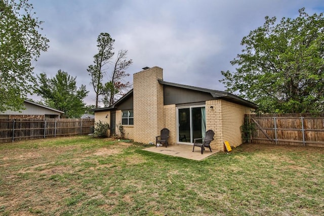 back of property featuring a yard and a patio area