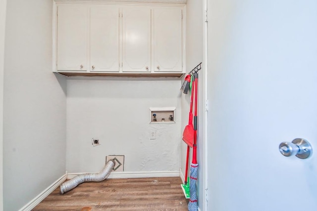 laundry area with electric dryer hookup, washer hookup, wood-type flooring, and cabinets