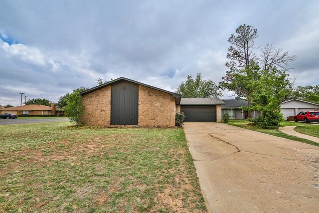 ranch-style home featuring a garage and a front lawn