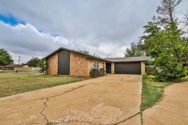 ranch-style house with a garage and a front yard