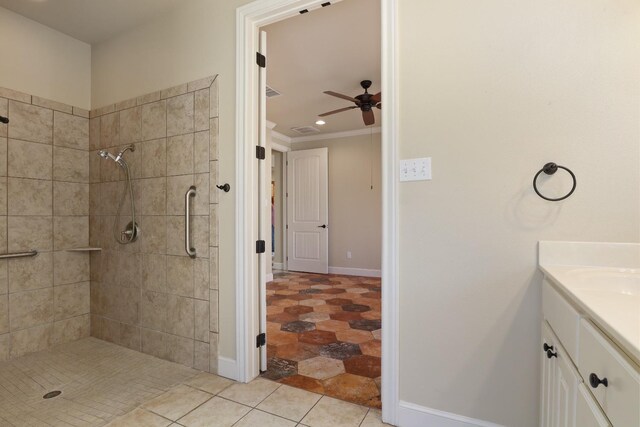 bathroom featuring crown molding, ceiling fan, tiled shower, vanity, and tile patterned floors