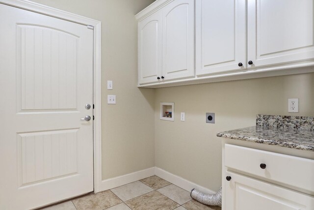 washroom featuring cabinets, washer hookup, light tile patterned floors, and electric dryer hookup