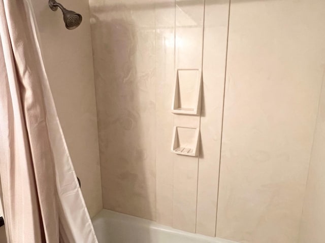 interior details featuring shower / bath combination with curtain