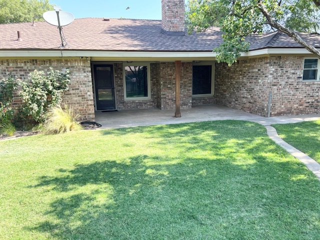 back of property with a patio and a yard