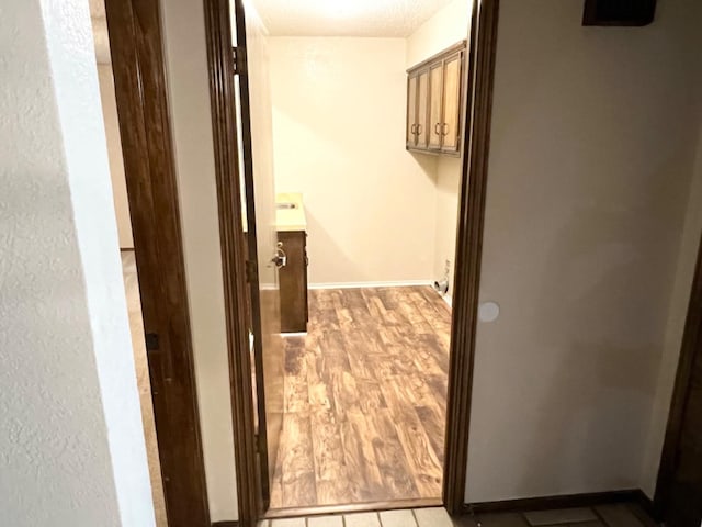 hallway with light hardwood / wood-style floors