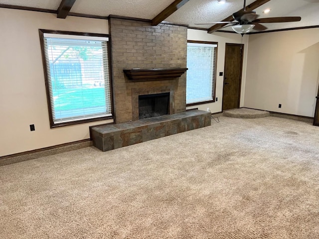 unfurnished living room featuring beamed ceiling, carpet floors, and a textured ceiling