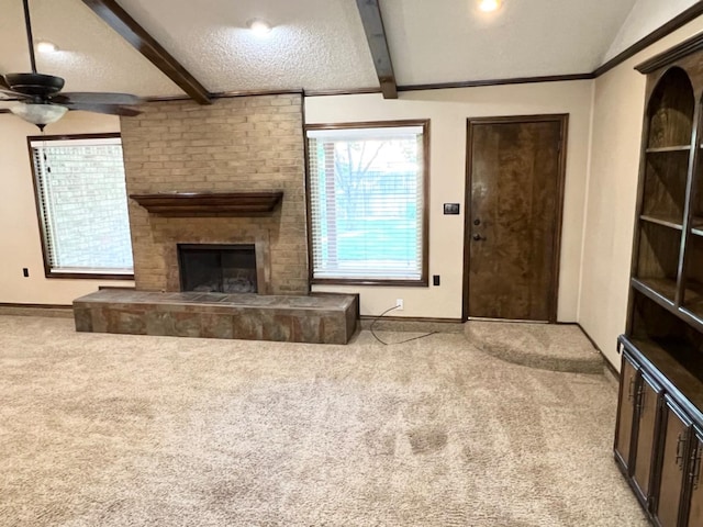 living room with vaulted ceiling with beams, a fireplace, light carpet, and a textured ceiling