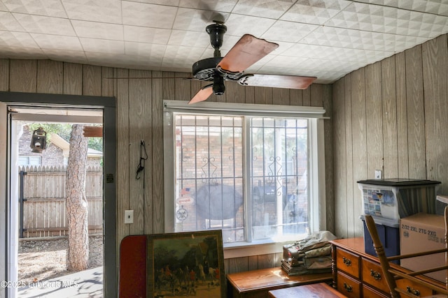 2512 Holliday Dr, Plainview, TX 79072 - dining area with wooden walls, a ceiling fan, and healthy amount of natural light