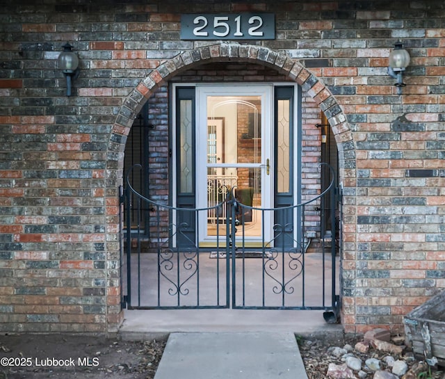 2512 Holliday Dr, Plainview, TX 79072 - property entrance with brick siding and a gate