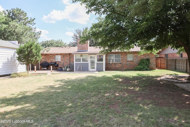 2512 Holliday Dr, Plainview, TX 79072 - back of house with a patio area, a chimney, and brick siding