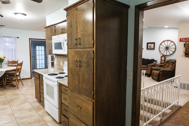 2512 Holliday Dr, Plainview, TX 79072 - kitchen with white appliances, tasteful backsplash, light countertops, light tile patterned floors, and ceiling fan