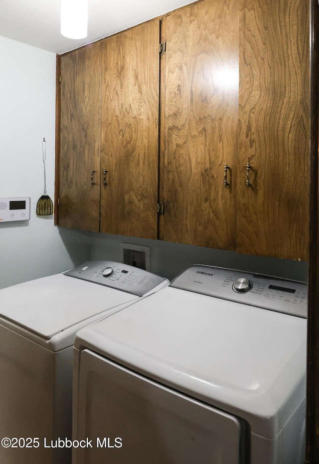 2512 Holliday Dr, Plainview, TX 79072 - laundry room with cabinet space and washing machine and clothes dryer