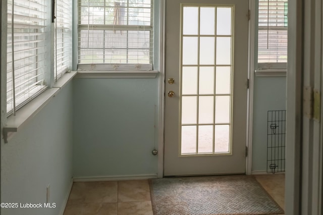 2512 Holliday Dr, Plainview, TX 79072 - entryway featuring baseboards and tile patterned flooring