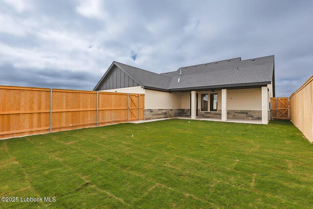 7450 55th St, Lubbock, TX 79407 - back of house featuring a patio area, roof with shingles, and board and batten siding