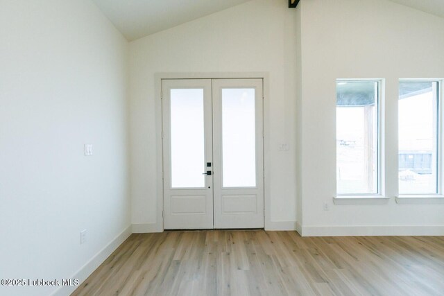 7450 55th St, Lubbock, TX 79407 - entrance foyer featuring lofted ceiling, light wood finished floors, french doors, and baseboards