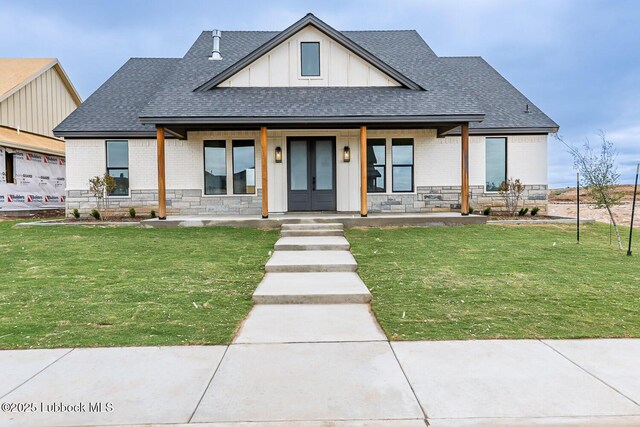 7450 55th St, Lubbock, TX 79407 - modern inspired farmhouse featuring a shingled roof, covered porch, stone siding, and board and batten siding