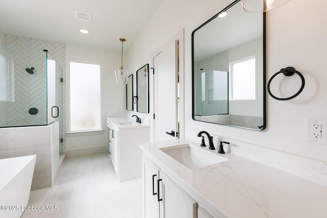 7450 55th St, Lubbock, TX 79407 - full bathroom featuring a shower stall, two vanities, a freestanding bath, recessed lighting, and tile patterned flooring