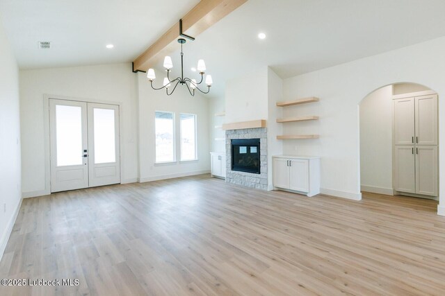 7450 55th St, Lubbock, TX 79407 - unfurnished living room featuring baseboards, light wood-style flooring, arched walkways, a chandelier, and recessed lighting