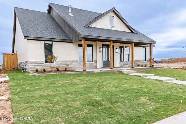 7450 55th St, Lubbock, TX 79407 - modern inspired farmhouse featuring a shingled roof, board and batten siding, a porch, a front lawn, and brick siding