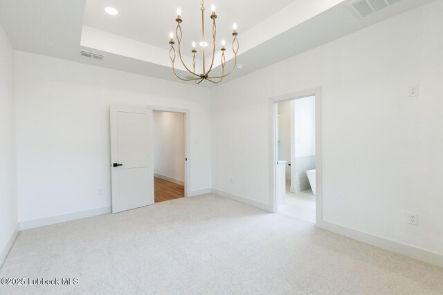 7450 55th St, Lubbock, TX 79407 - empty room with a chandelier, light colored carpet, a tray ceiling, baseboards, and recessed lighting