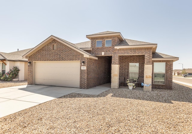 3202 Venita Ave, Lubbock, TX 79407 - view of front of house with brick siding, an attached garage, roof with shingles, and driveway