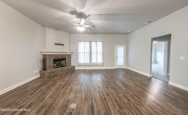 3202 Venita Ave, Lubbock, TX 79407 - unfurnished living room featuring a ceiling fan, dark wood-type flooring, and a fireplace