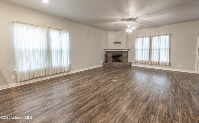 3202 Venita Ave, Lubbock, TX 79407 - unfurnished living room with a ceiling fan, dark wood-type flooring, and a brick fireplace