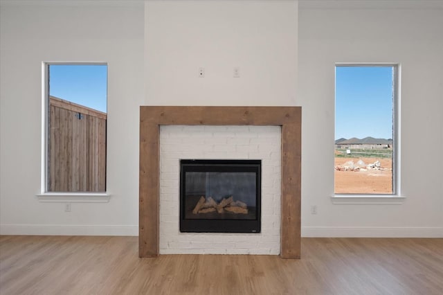 room details with a brick fireplace and hardwood / wood-style floors