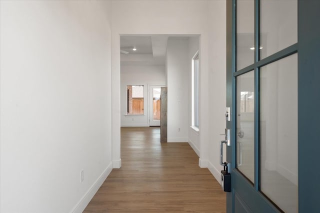 corridor with hardwood / wood-style flooring