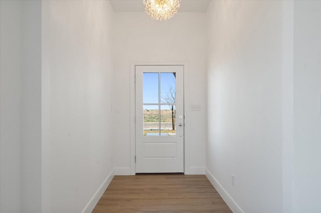 entryway featuring a chandelier and light hardwood / wood-style floors