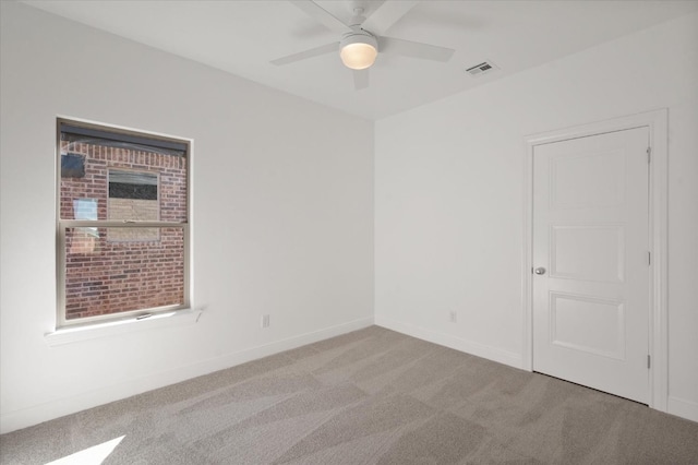 carpeted spare room with ceiling fan