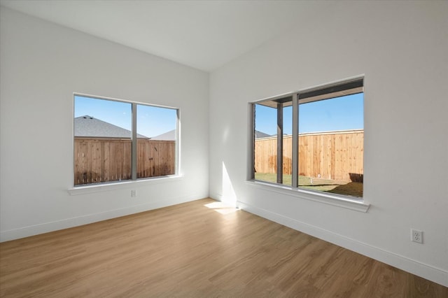 unfurnished room with wood-type flooring and plenty of natural light