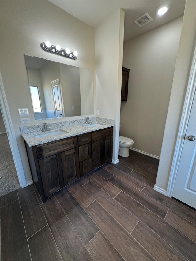 bathroom with vanity and toilet