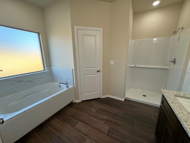 bathroom featuring vanity and separate shower and tub