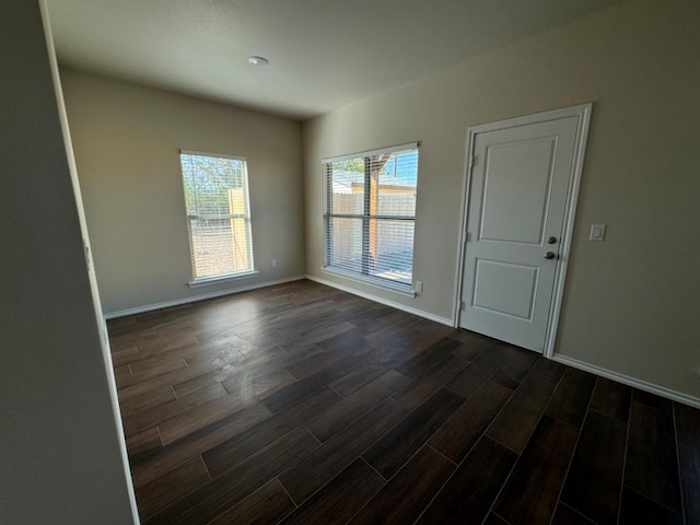 spare room featuring dark hardwood / wood-style floors