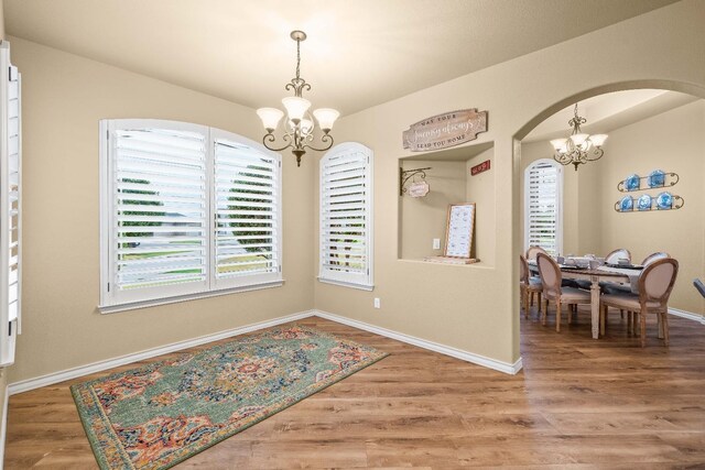 dining room featuring a notable chandelier and hardwood / wood-style flooring