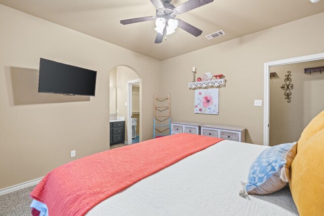 bedroom with connected bathroom, carpet floors, and ceiling fan