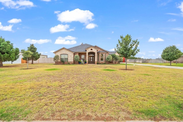 single story home featuring a front yard